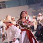 María José Hernández Vera, Flor Tabasco, Luciendo El Traje Regional E Interpretando Una Danza Tradicional Junto A Un Bailador En Un Escenario Cultural.