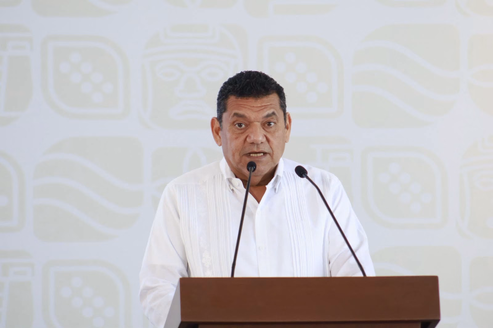 Javier May Presenta Intensa Agenda Semanal: Obras, Programas Sociales, Balance Ambiental Y Avances Legislativos En Tabasco 72 El Gobernador De Tabasco, Javier May Rodríguez, Vistiendo Una Guayabera Blanca, Al Frente De Un Pódium De Madera Con Micrófonos Durante La Conferencia De Prensa Matutina.